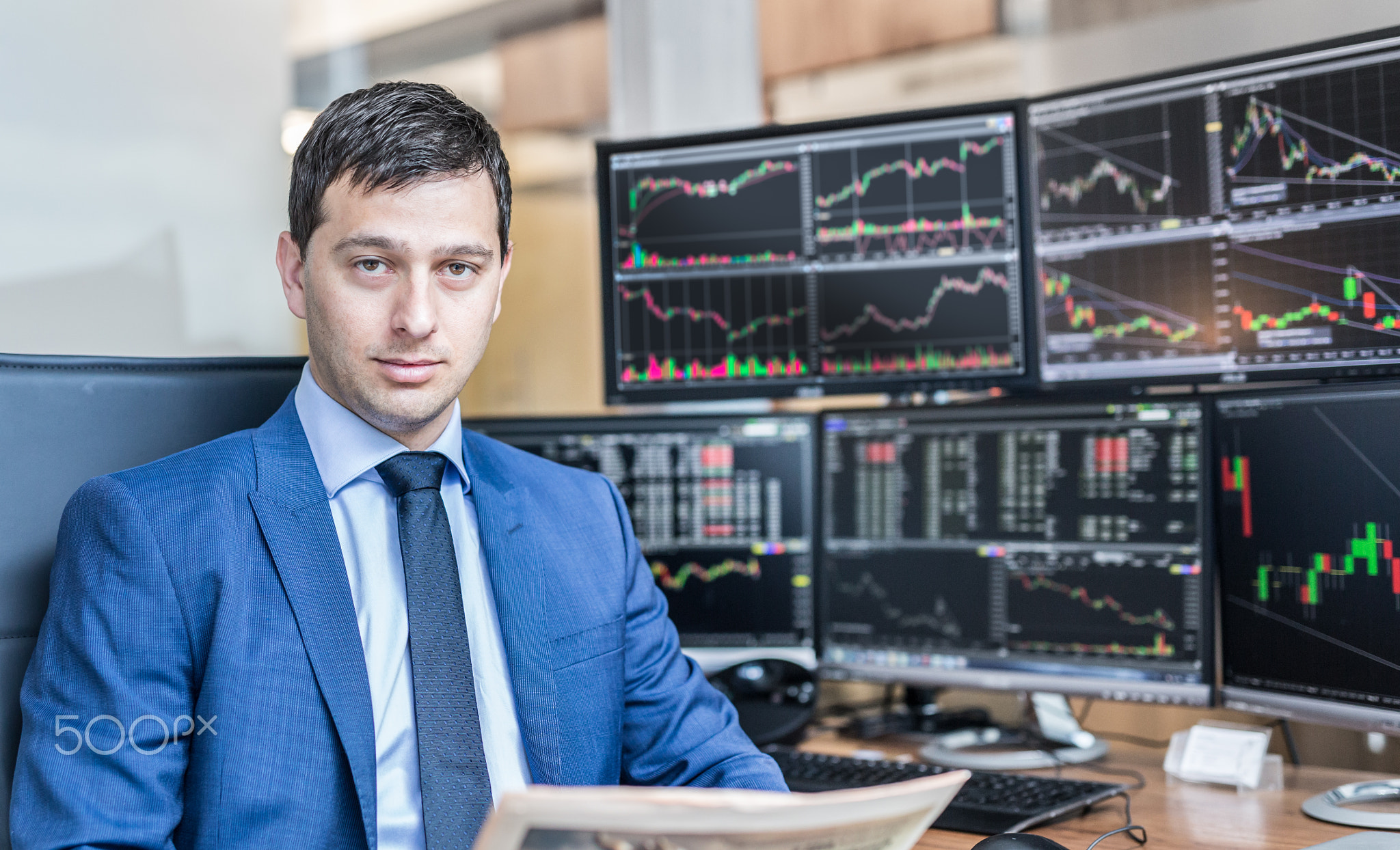 Business portrait of stock broker in traiding office.