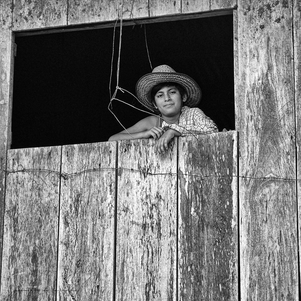 Olympus XZ-1 sample photo. Boy in window photography