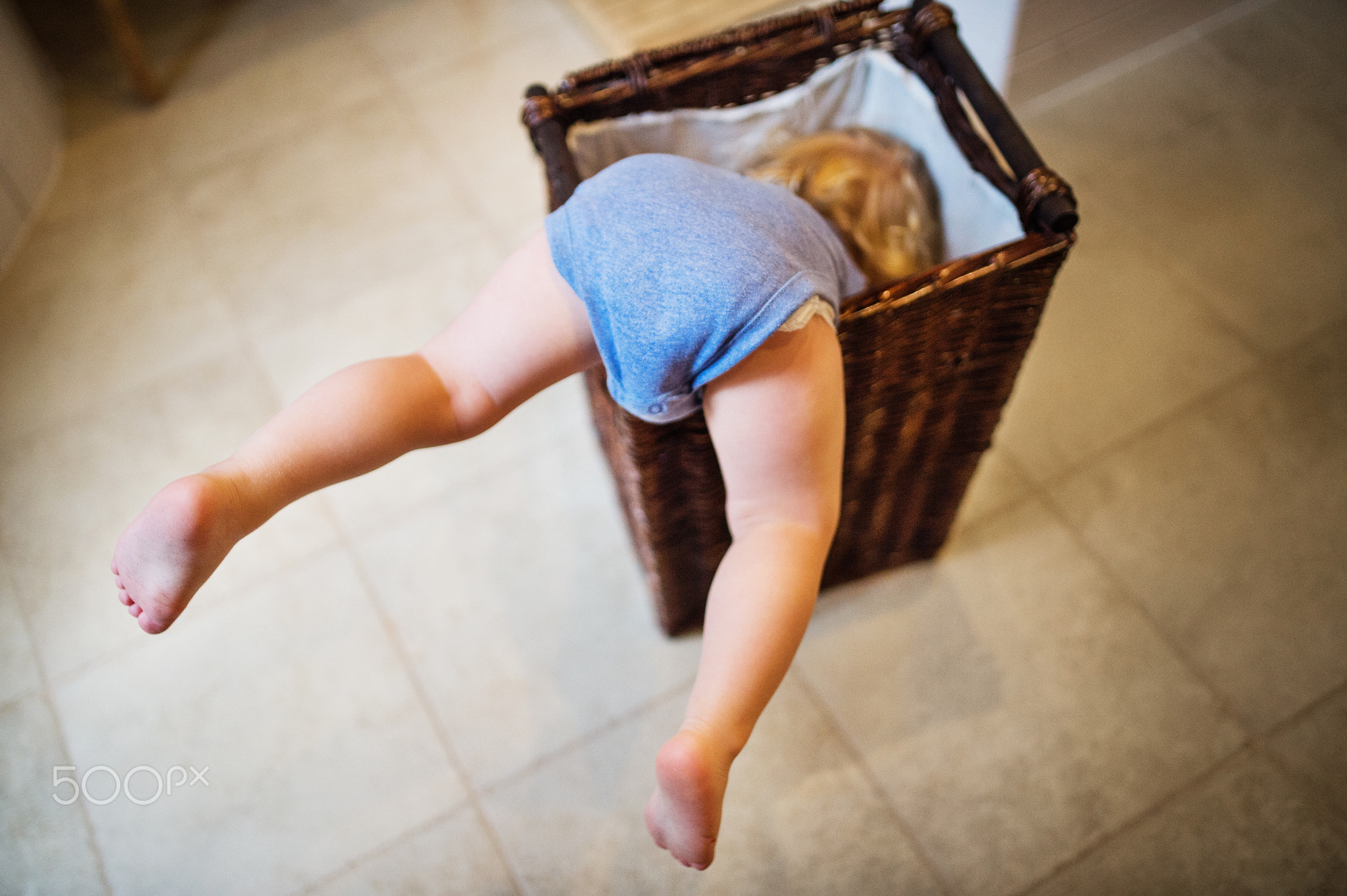 Toddler boy in a dangerous situation in the bathroom.