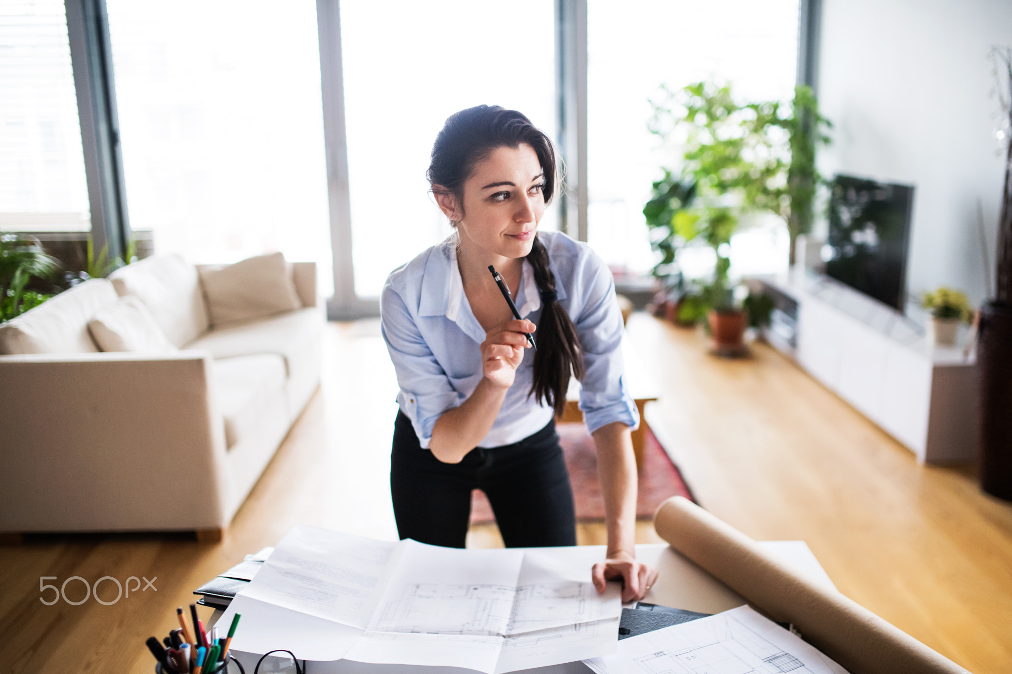 A portrait of a woman working at home.