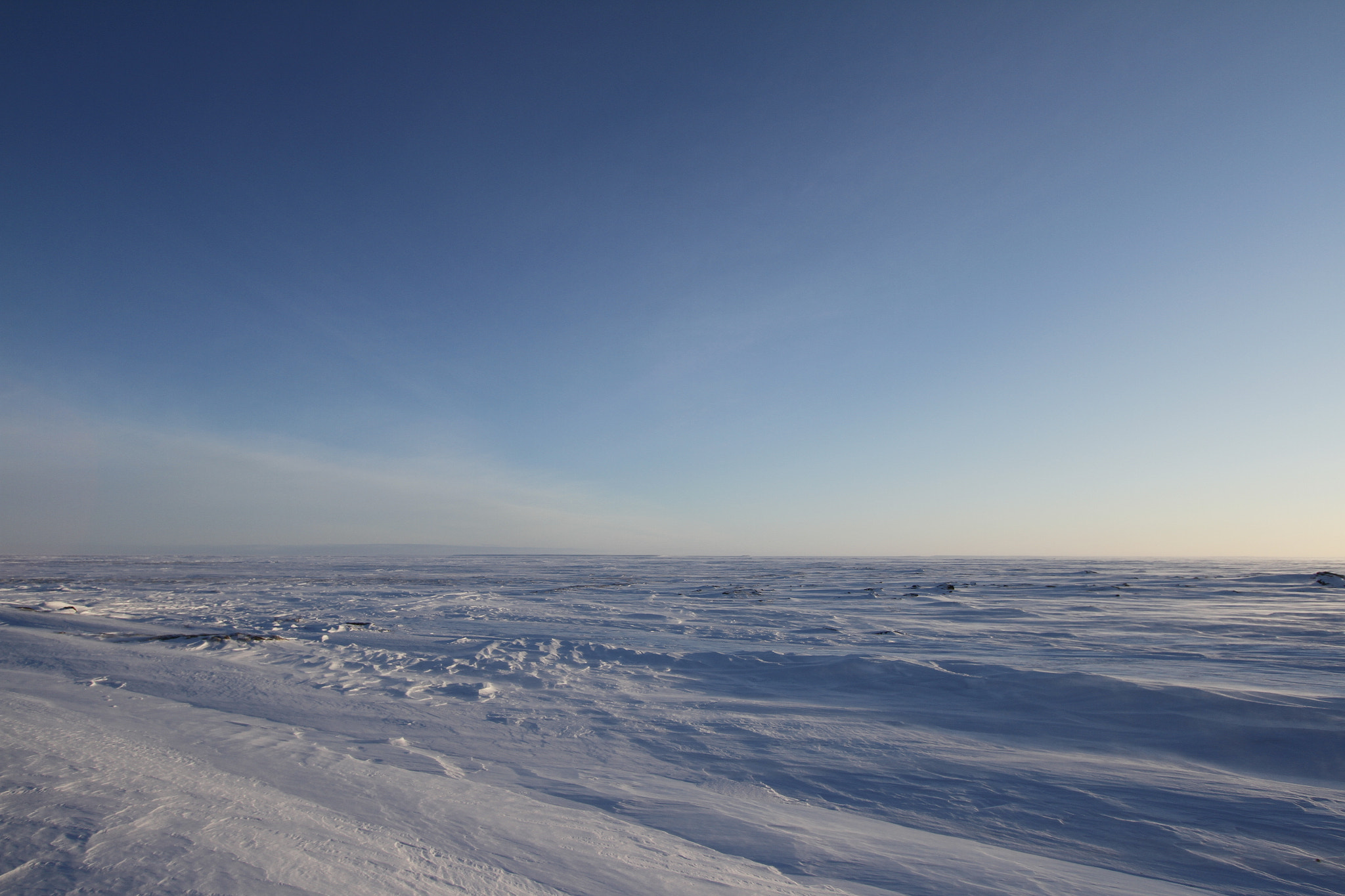 Canon EF-S 10-22mm F3.5-4.5 USM sample photo. White winter arctic landscape with blowing snow on the ground a blue endless sky photography
