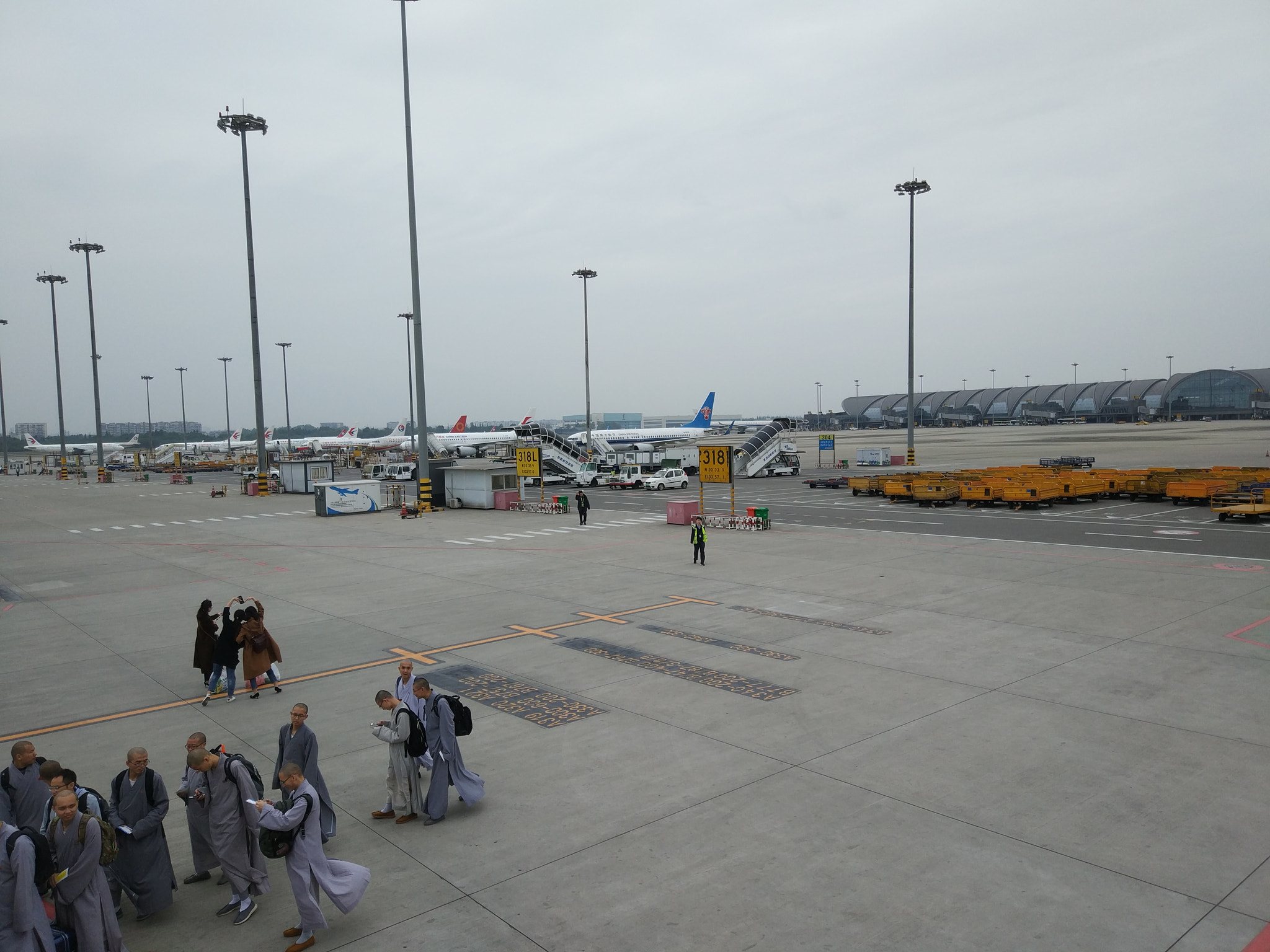 Xiaomi MI 5s sample photo. A group of monks are queuing up to get on the plane photography