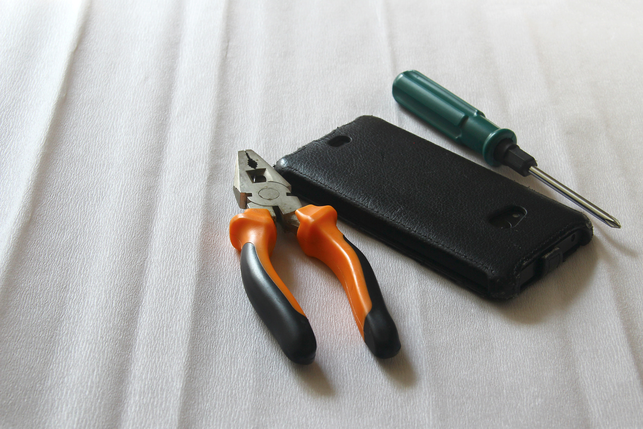 pliers, screwdriver and telephone