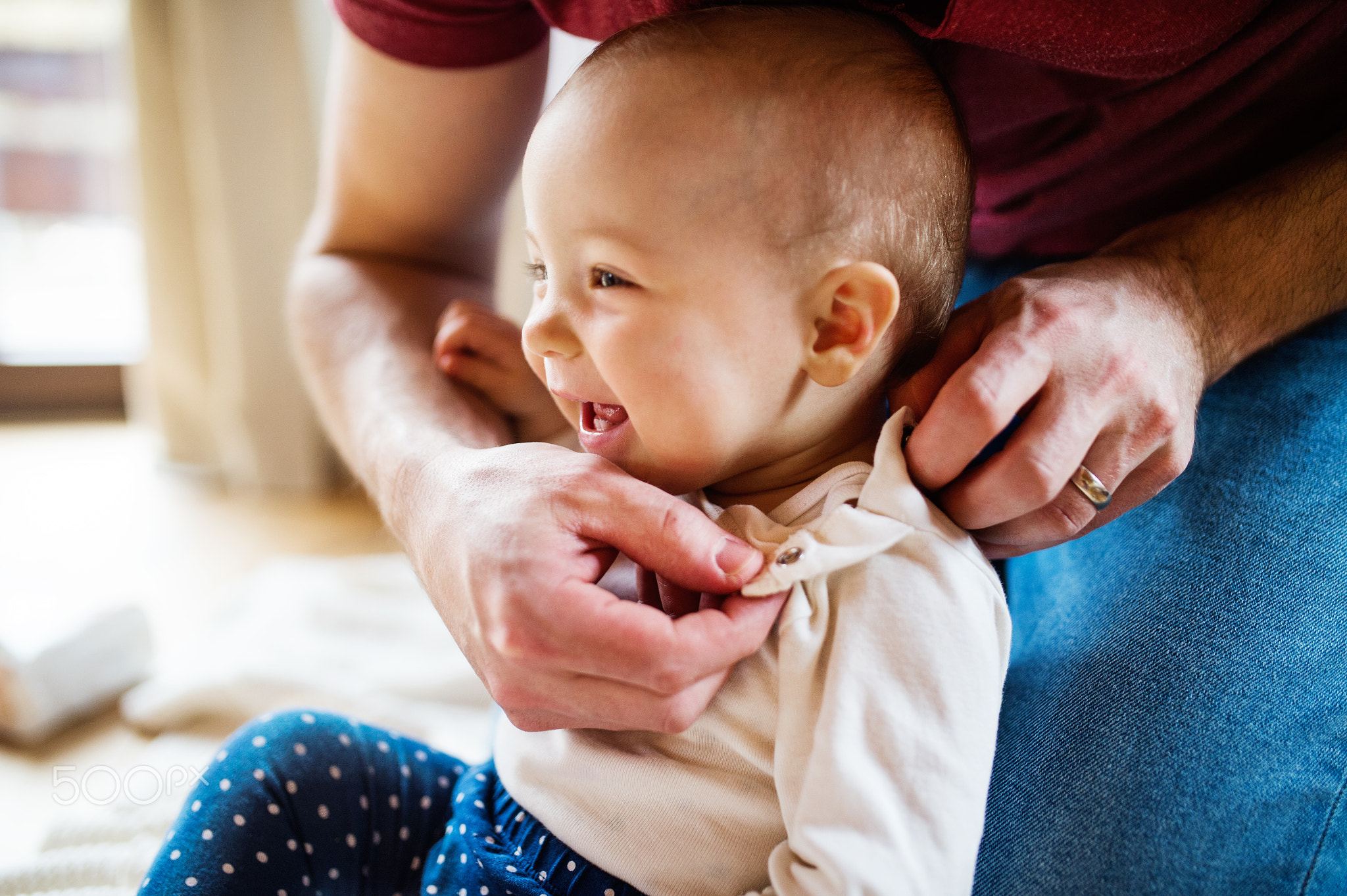 Father with a baby girl at home.