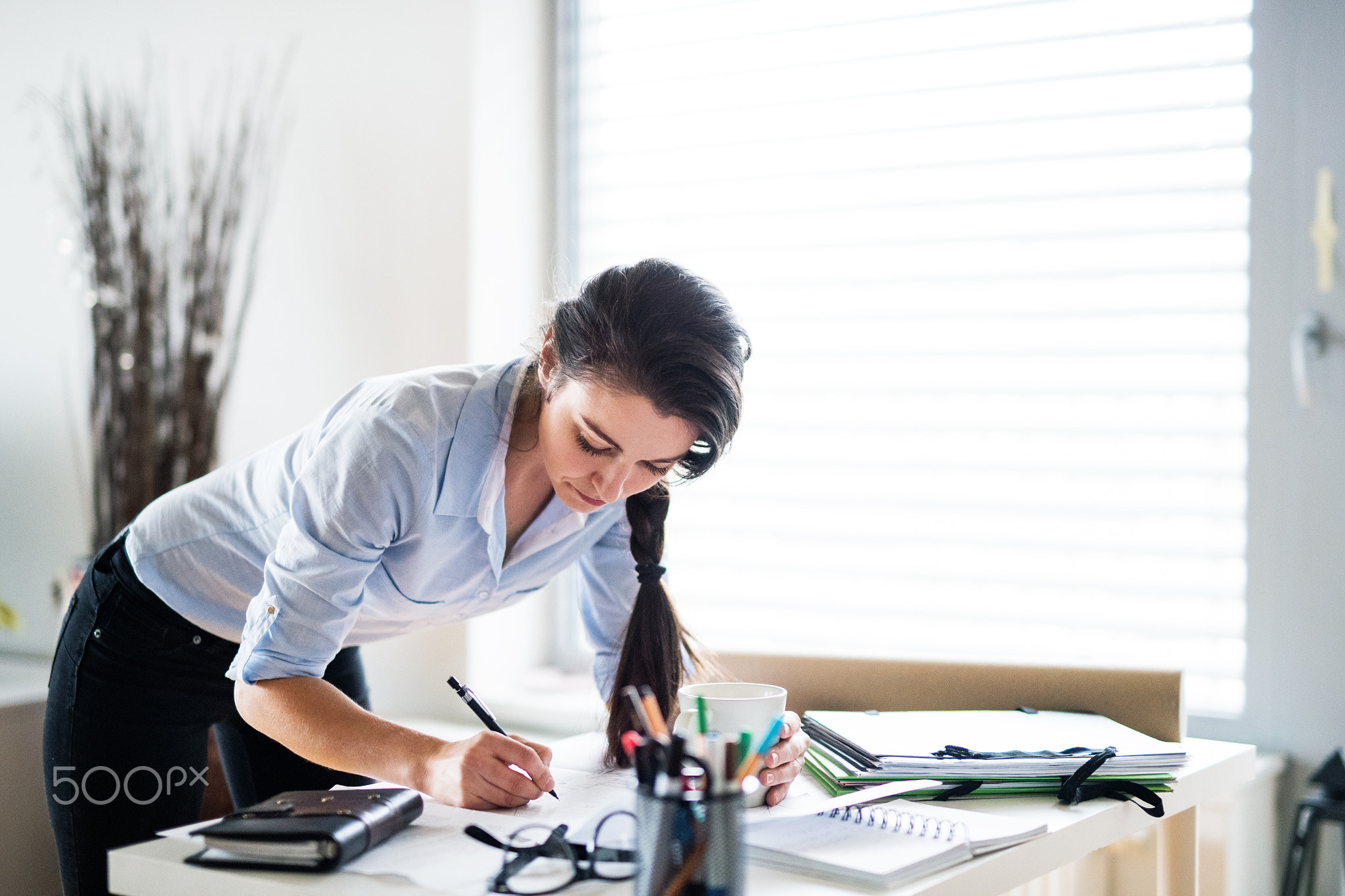 A portrait of a woman working at home.