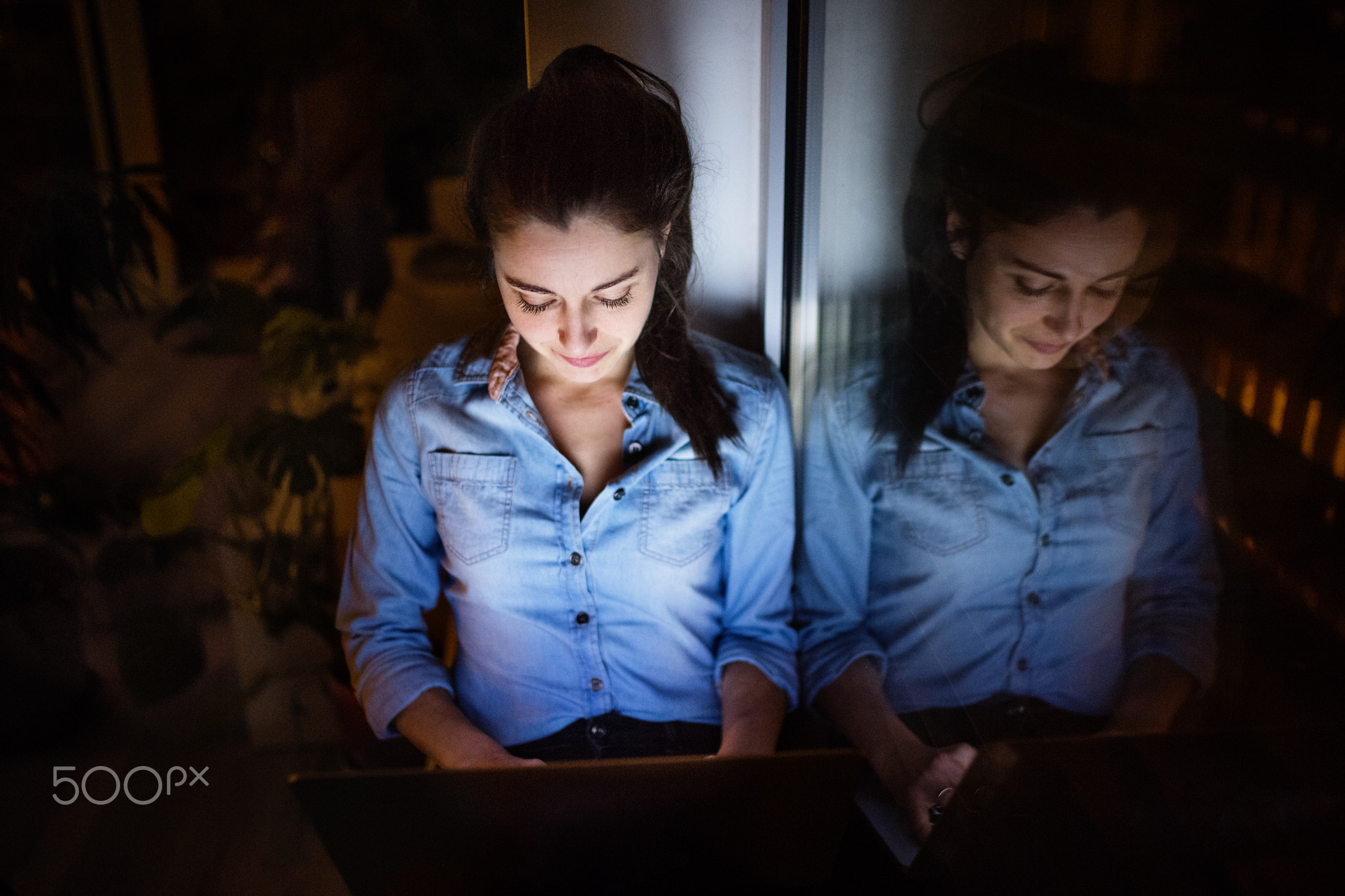 A woman working on a laptop.