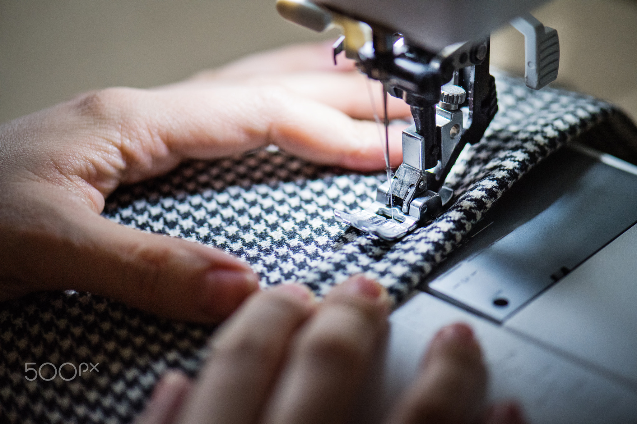 Young woman using sewing machine, startup business.