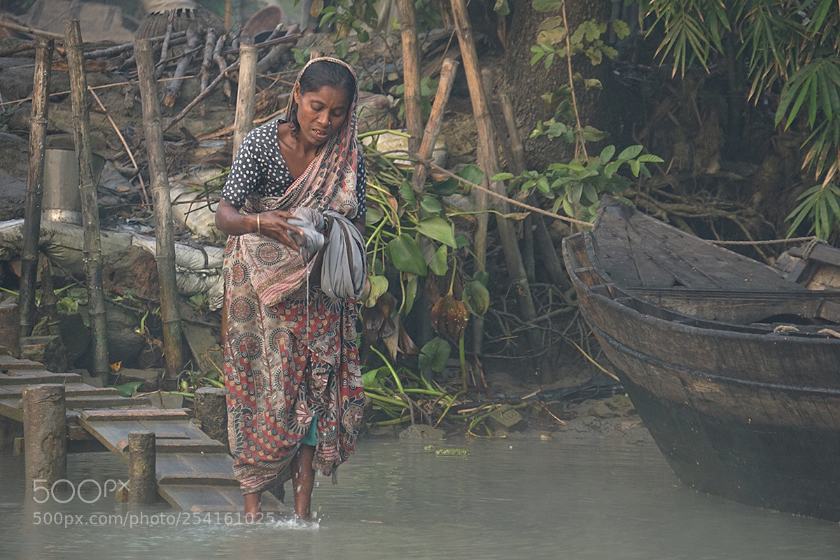 Sony a6000 sample photo. Woman washing clothes along photography