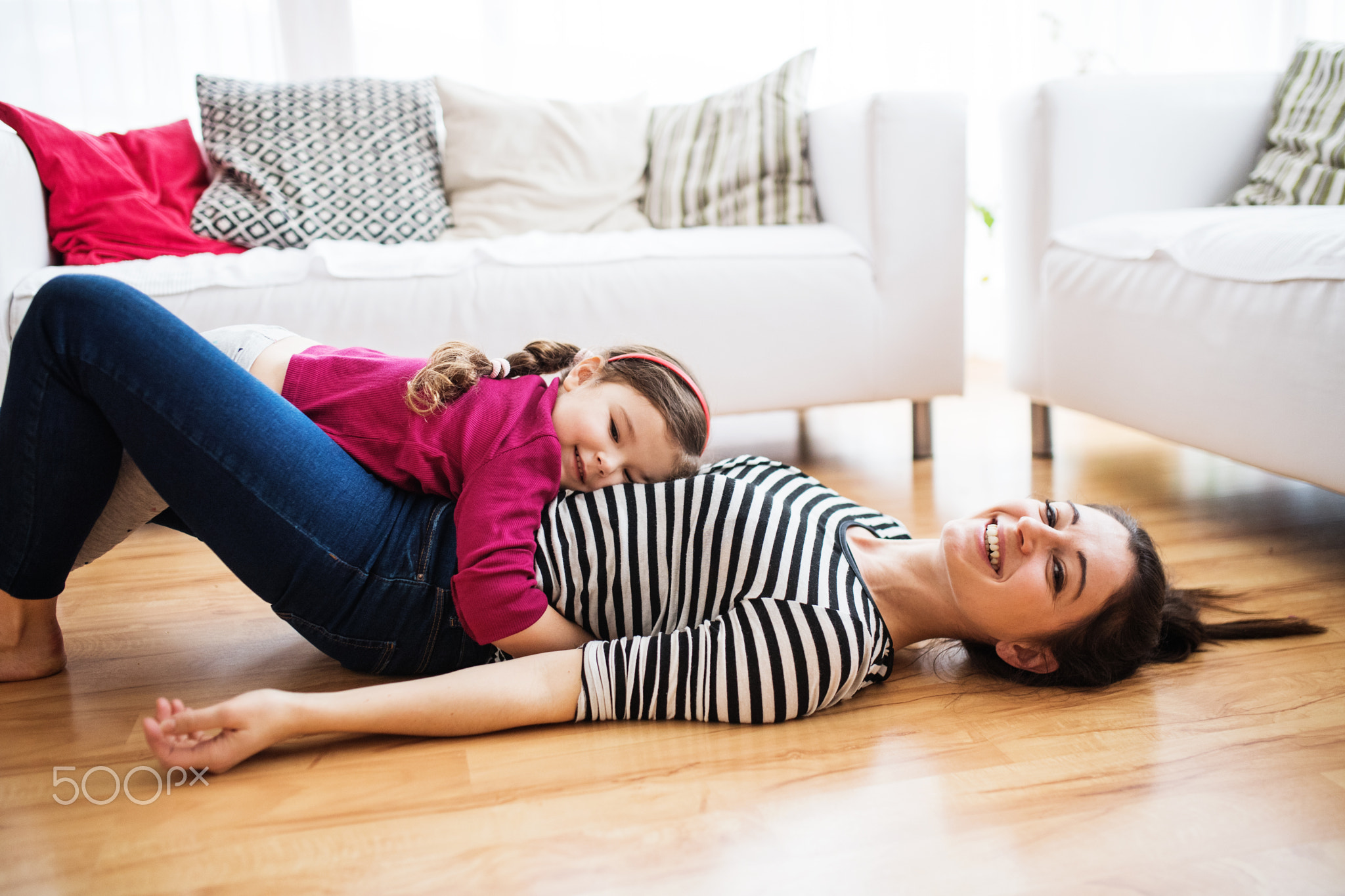 Young mother with a small girl at home.