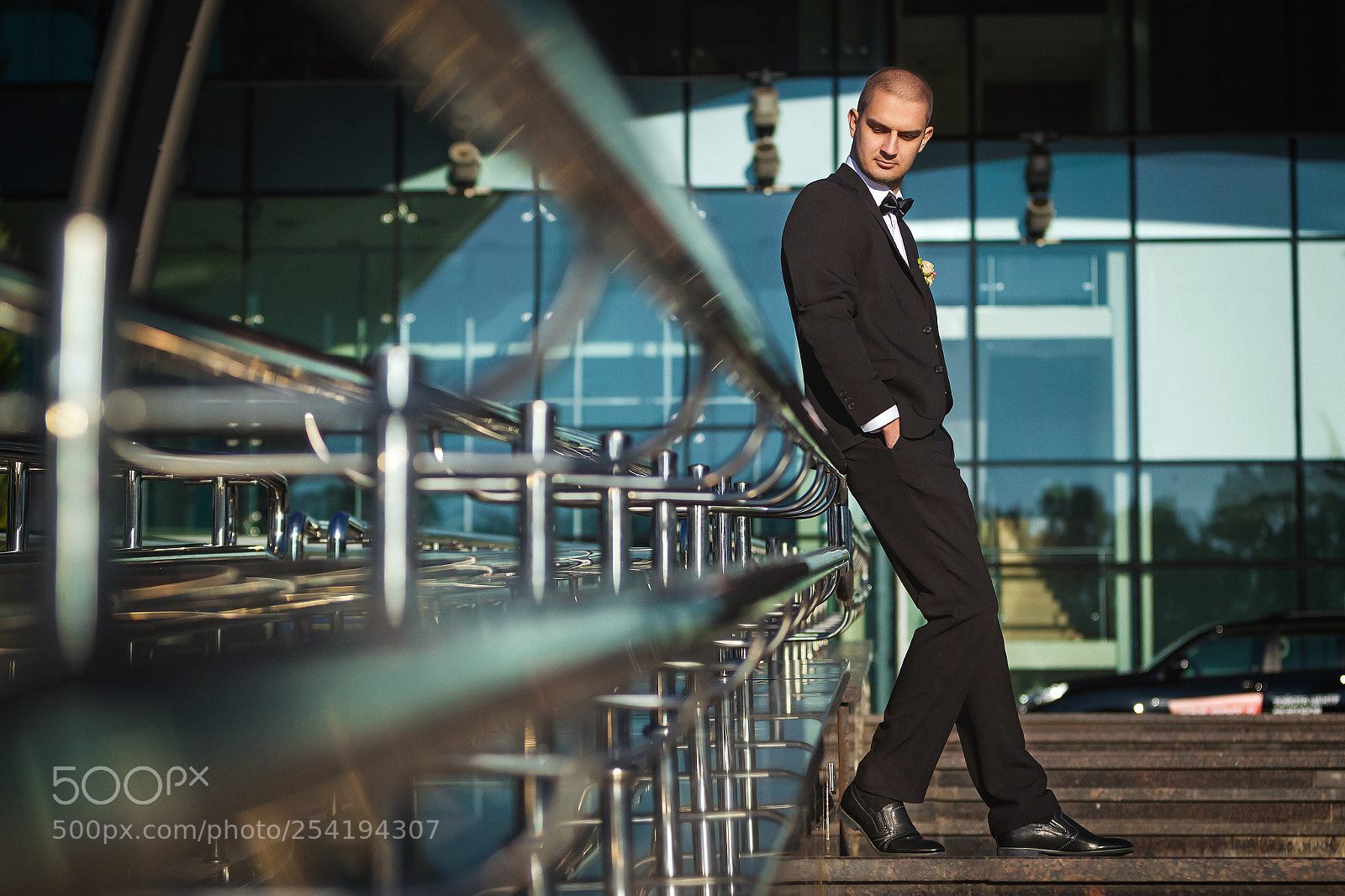 Canon EOS-1D Mark IV sample photo. Handsome groom leaning on photography