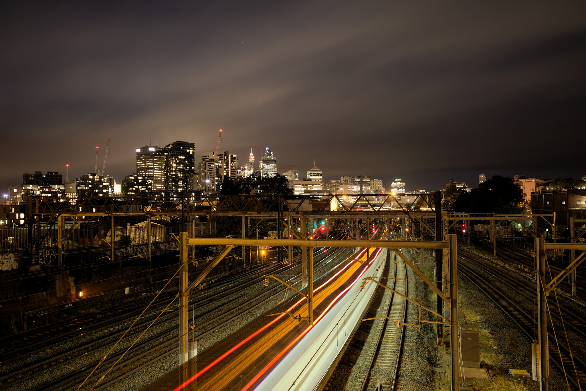Canon EF 16-35mm F4L IS USM sample photo. Light stretches over train tracks 2 photography