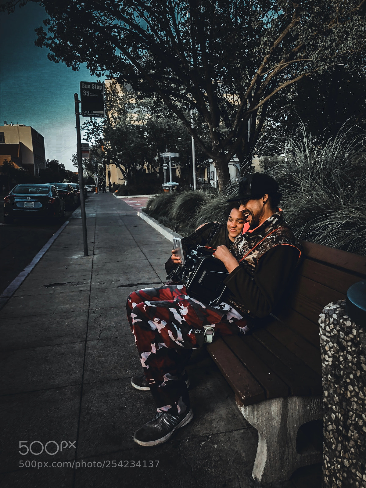 Apple iPhone X sample photo. Couple looking at a photography