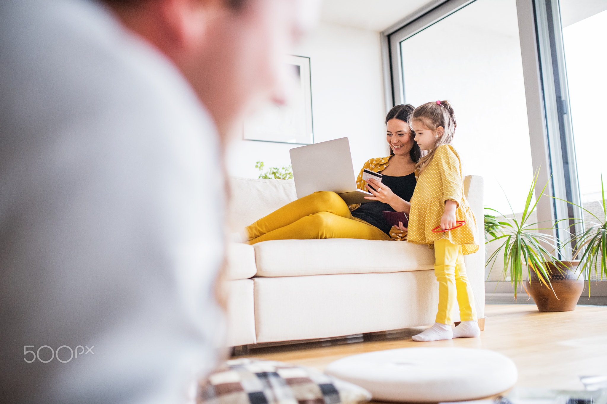 Young family with laptop preparing for holidays.