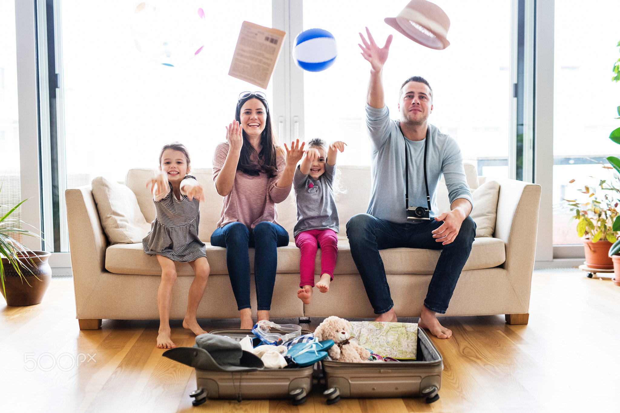 Young family with two children packing for holiday.