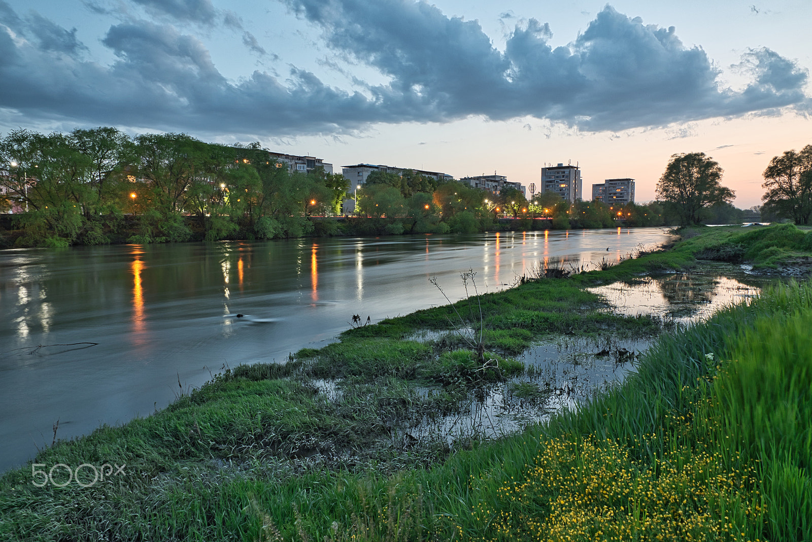 Nikon D5600 sample photo. A sunset over a river flowing across a city photography