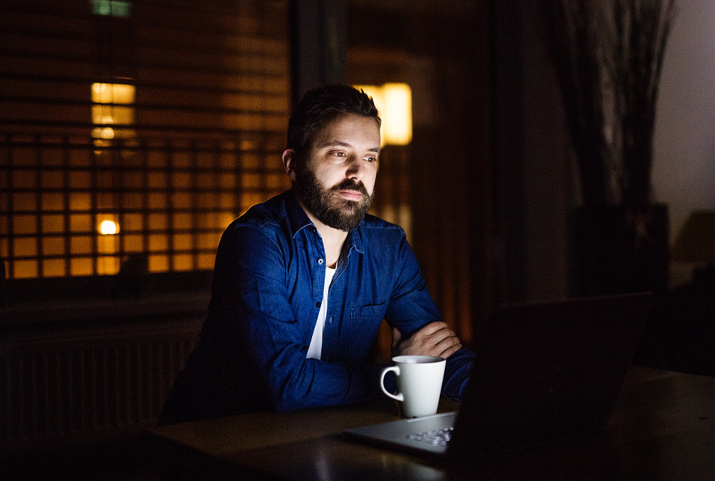 A man working on a laptop at home at night. by Jozef Polc on 500px.com