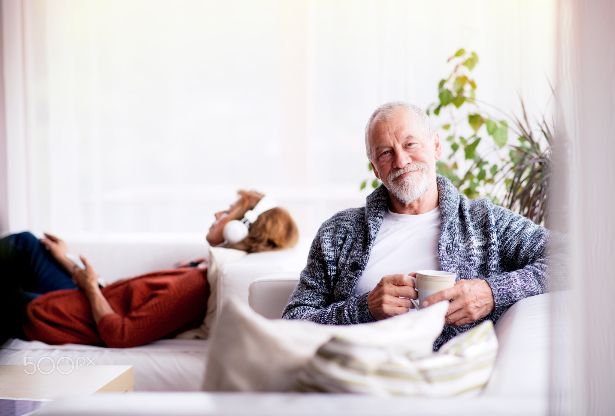 Senior couple sitting on the sofa and relaxing at home.