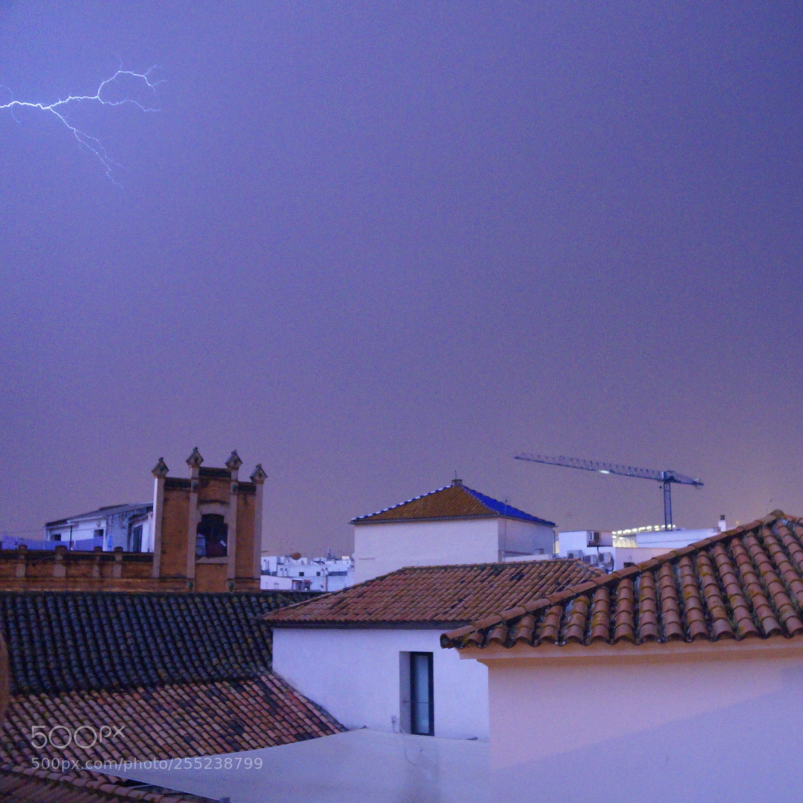 Sony SLT-A37 sample photo. Seville rooftops and lightning photography