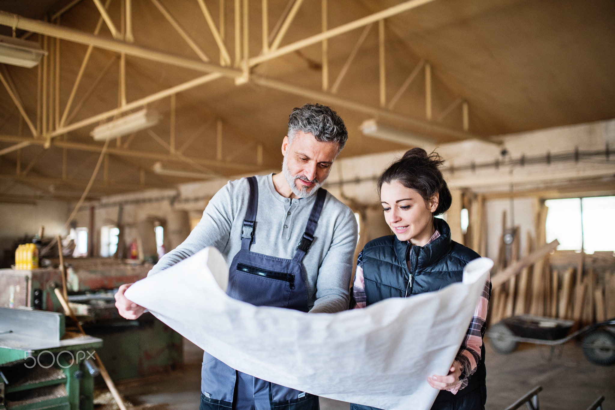 Man and woman workers in the carpentry workshop.