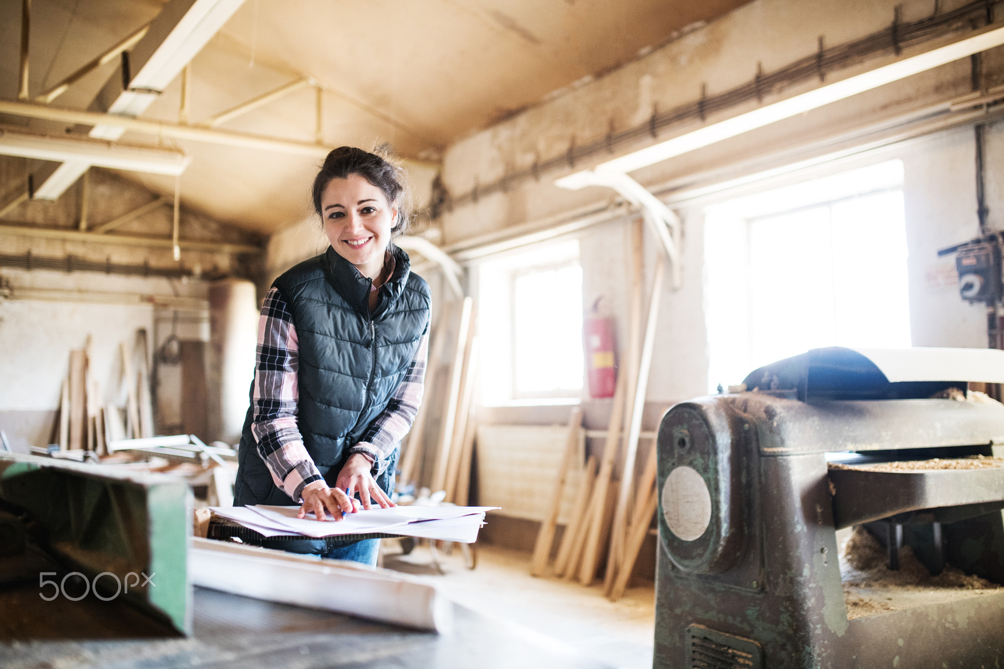 Portrait of a woman worker in the carpentry workshop.