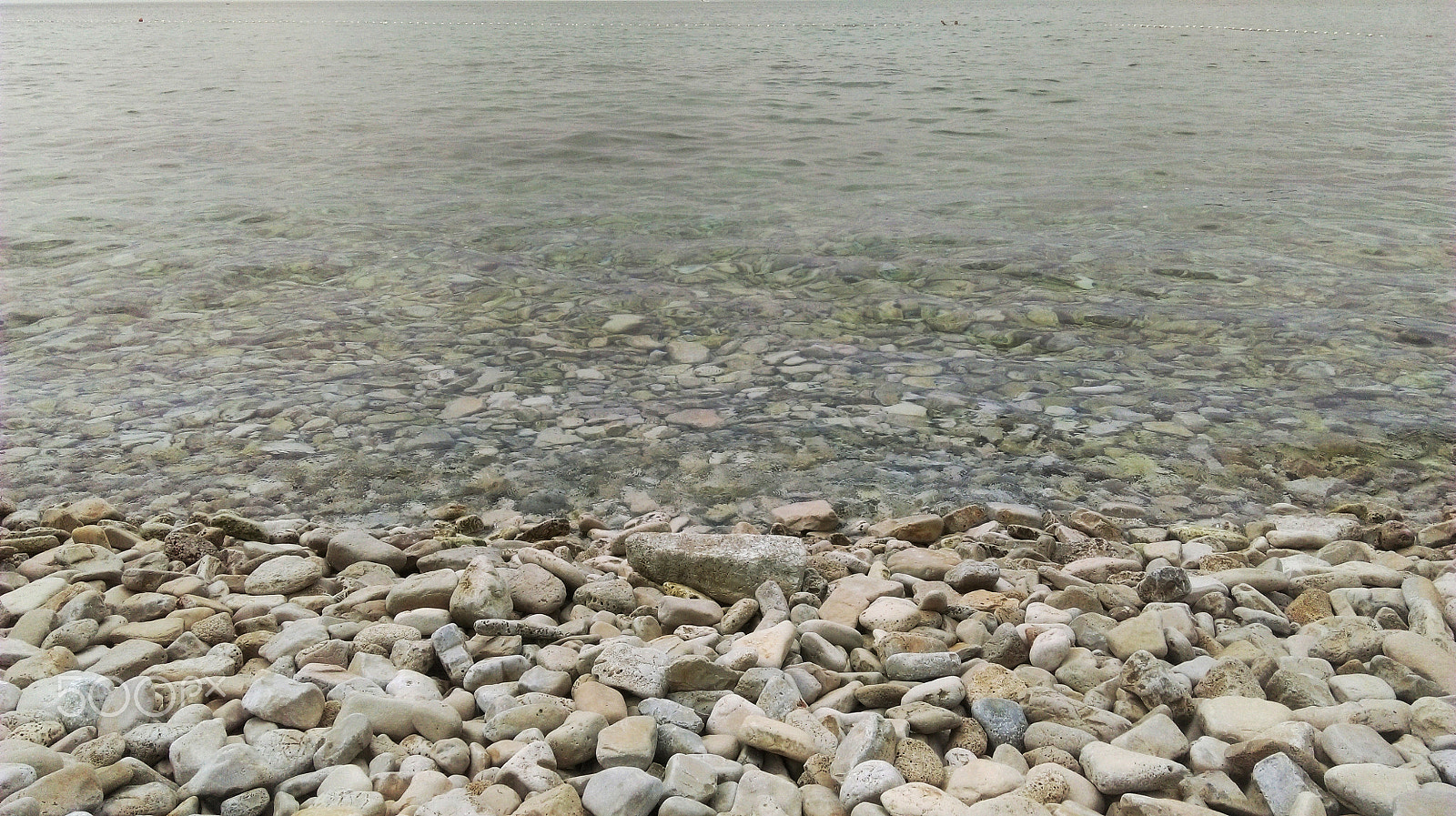 HTC DESIRE 826 DUAL SIM sample photo. The beach with colorful pebbles and a bustling ocean photography