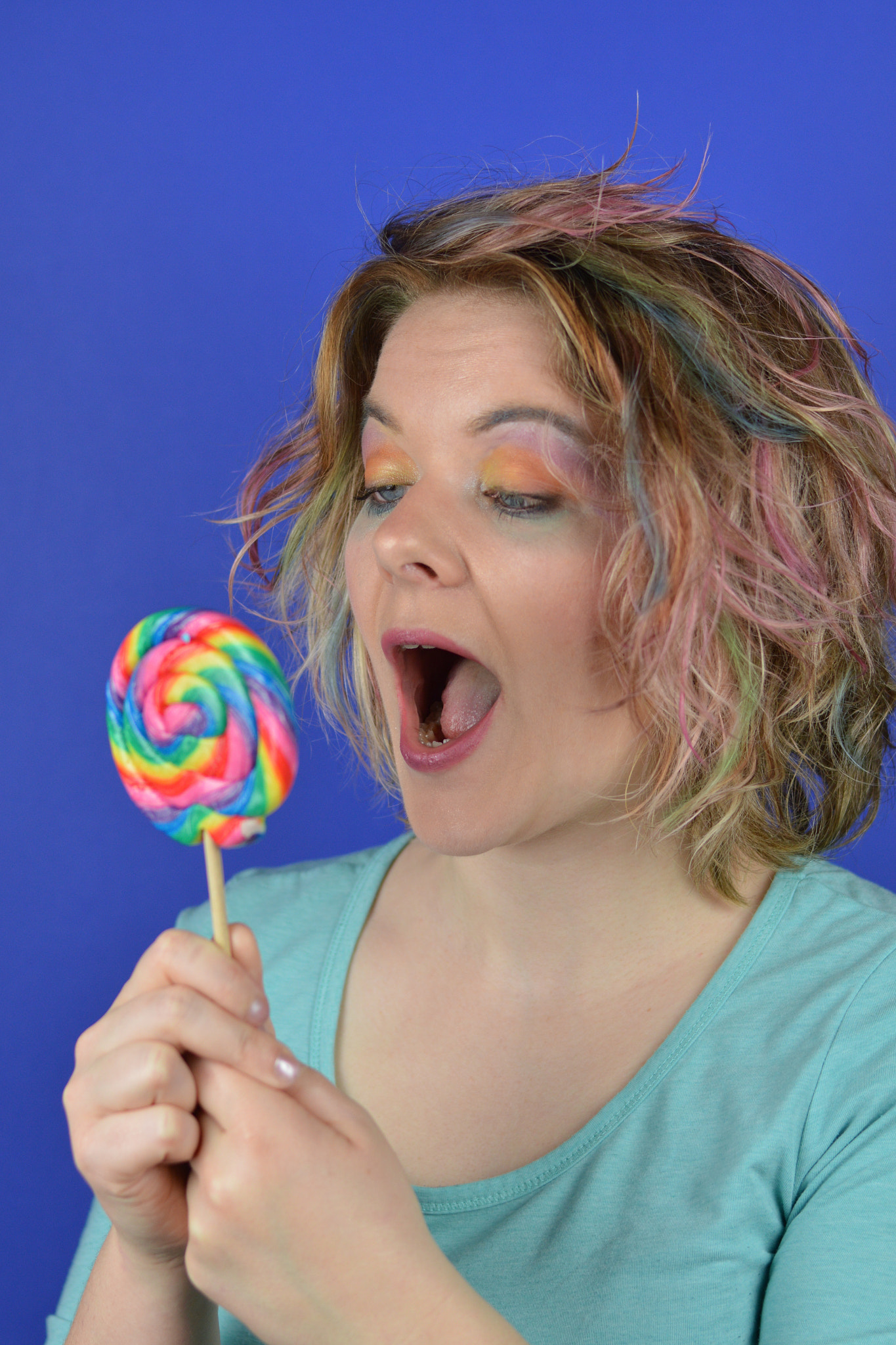 Nikon D3200 + Nikon AF-S Nikkor 50mm F1.8G sample photo. Young blond woman looking at big lollipop photography