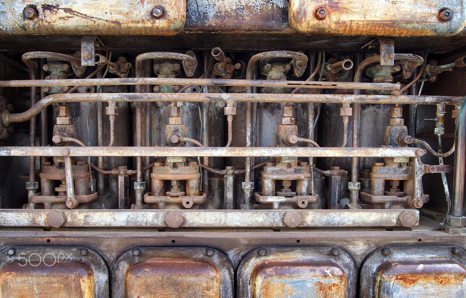 Olympus PEN E-PL6 sample photo. Close up of an old big rusting diesel combustion engine with cylinders rods and pipes photography