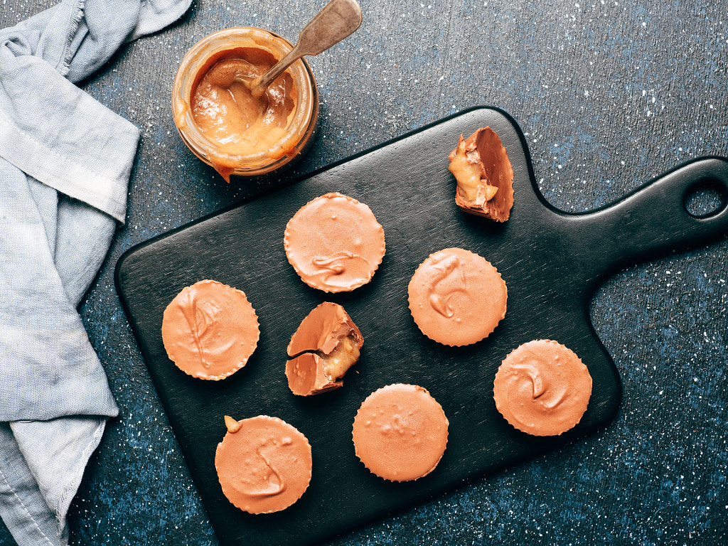 Stack of vegan chocolate cups with caramel on white by Fascinadora on 500px.com