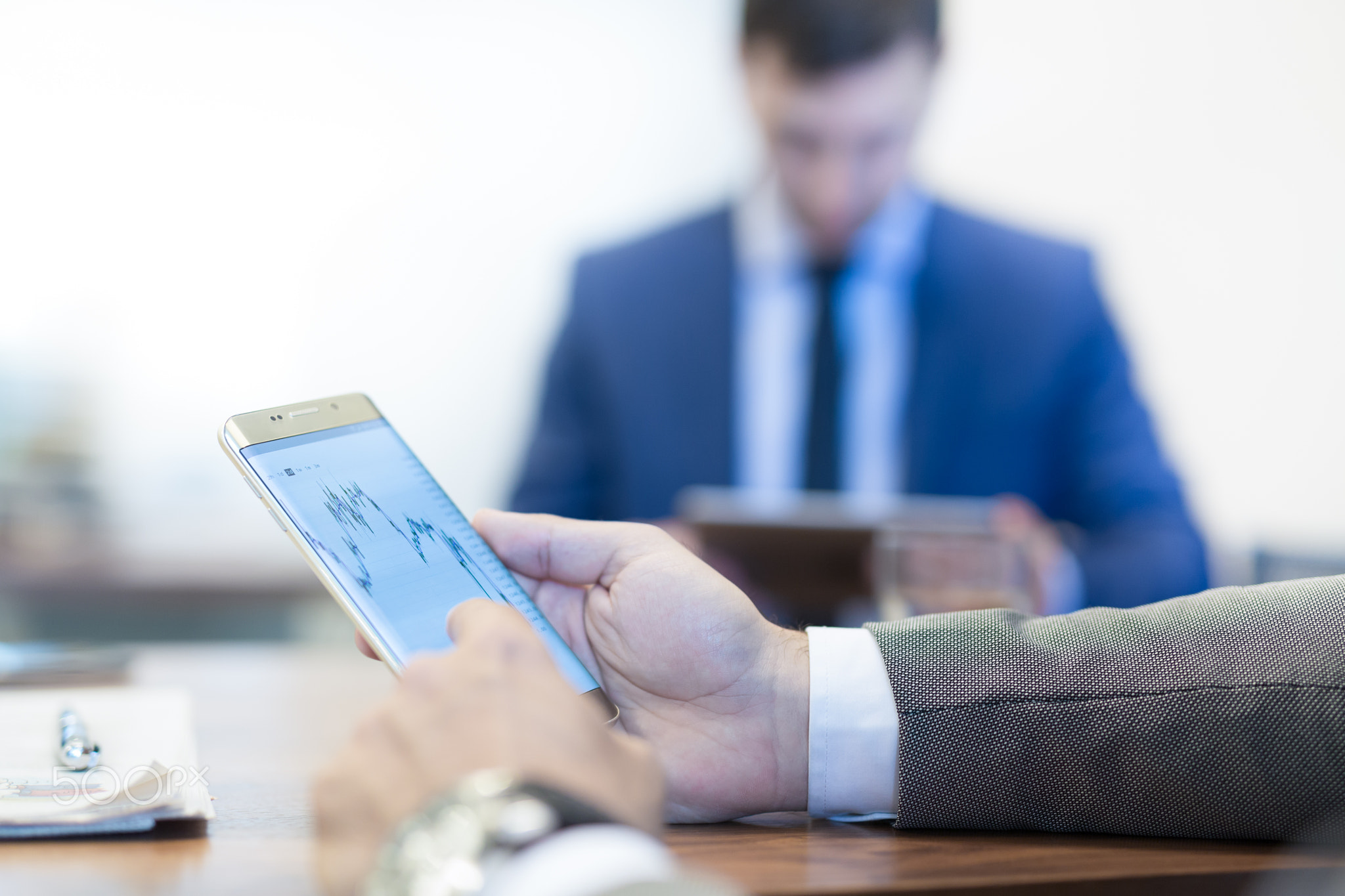 Close up of businessman using mobile smart phone.