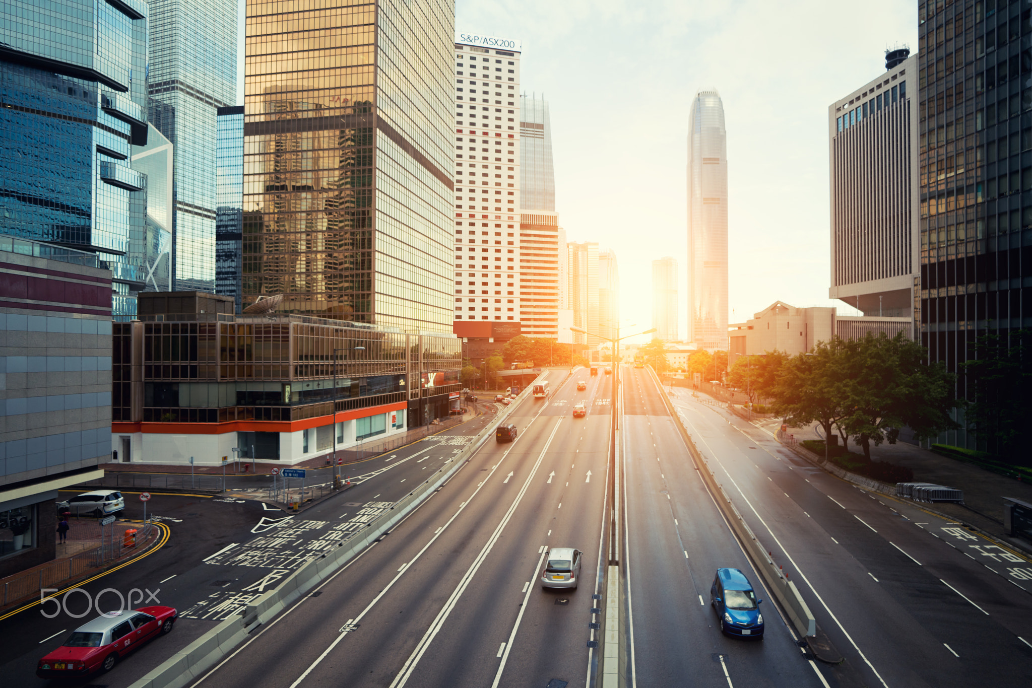 Hong Kong street with traffic and skyscraper office in morning i