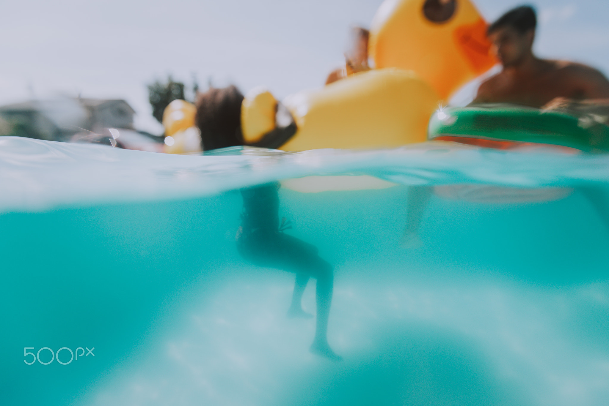 Blurred concept of friends having fun underwater in the swimming