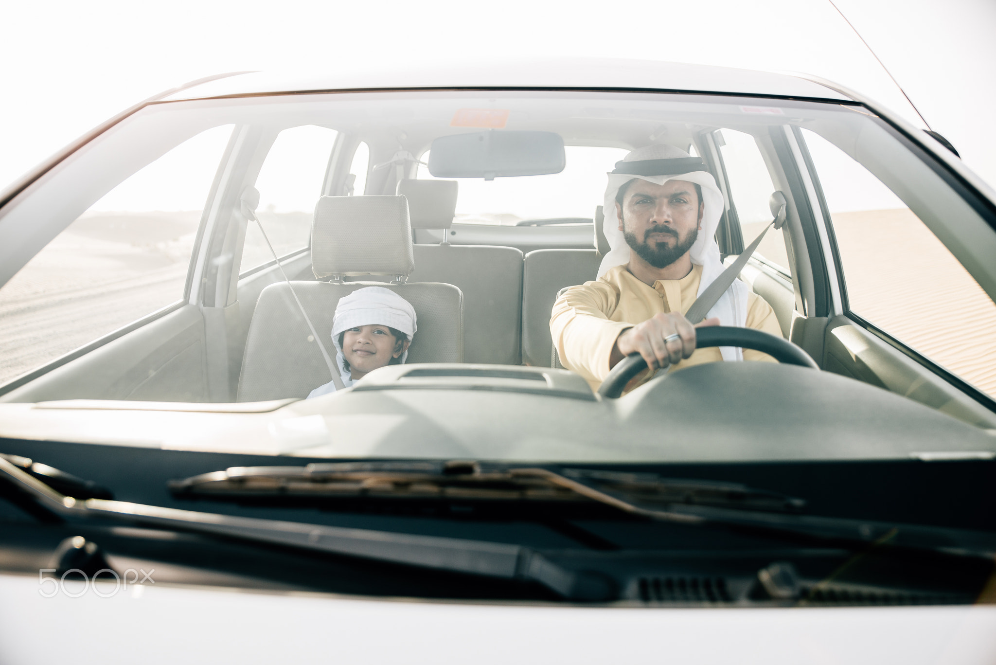 father and son spending time,driving  in the desert