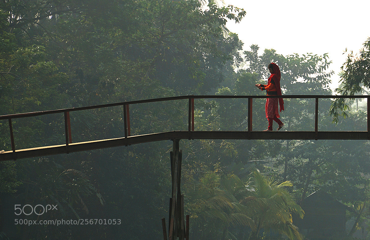 Sony a6000 sample photo. Girl crossing footbridge bangladesh photography