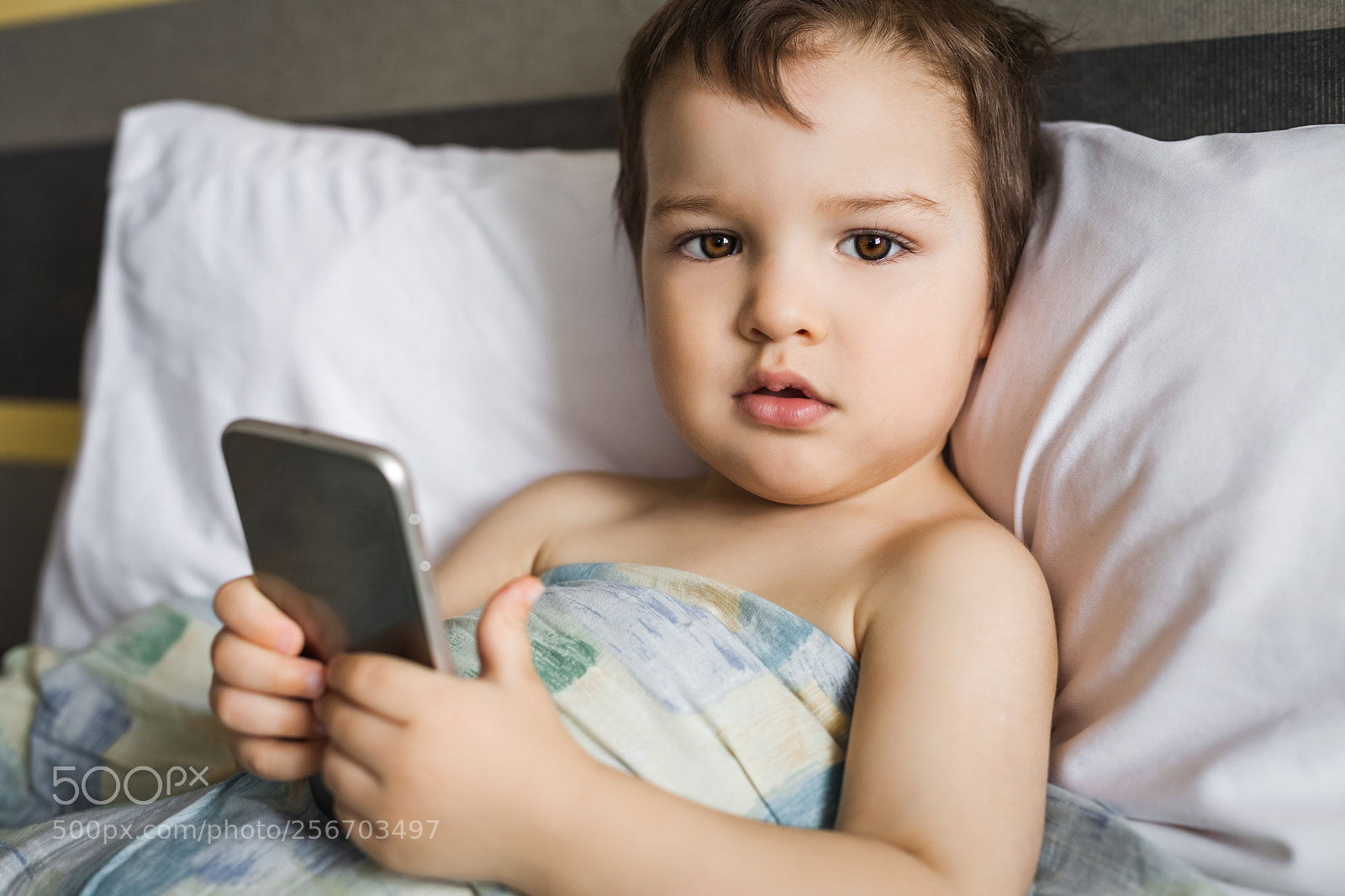 Canon EOS 5D Mark II sample photo. Boy holding phone lying photography