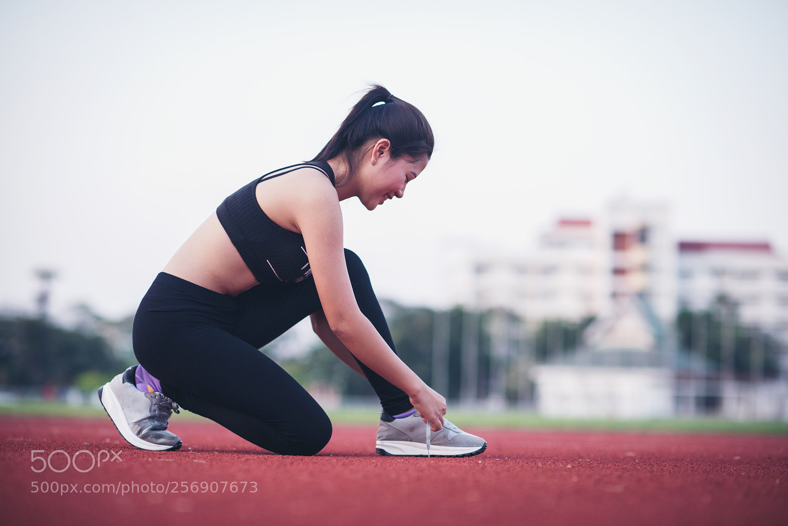 Nikon D800 sample photo. Young sportswoman tying shoelaces photography