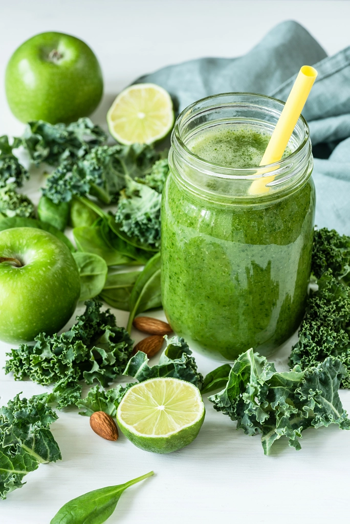 Green detox smoothie or blended juice in glass bottle on white by Vladislav Nosick on 500px.com