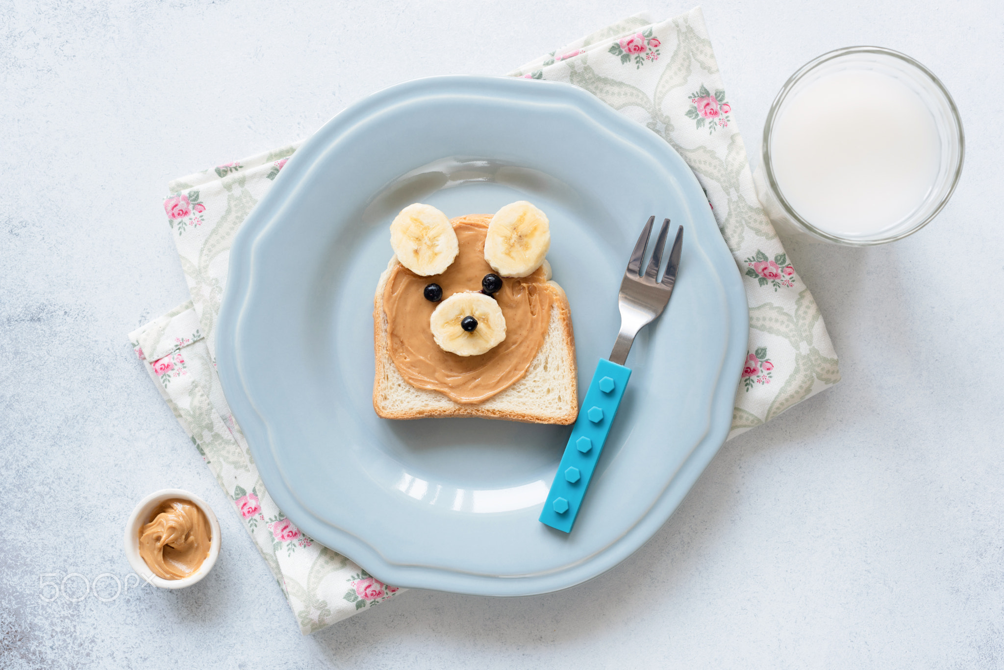 Banana peanut butter toast on a blue plate, meal for kids