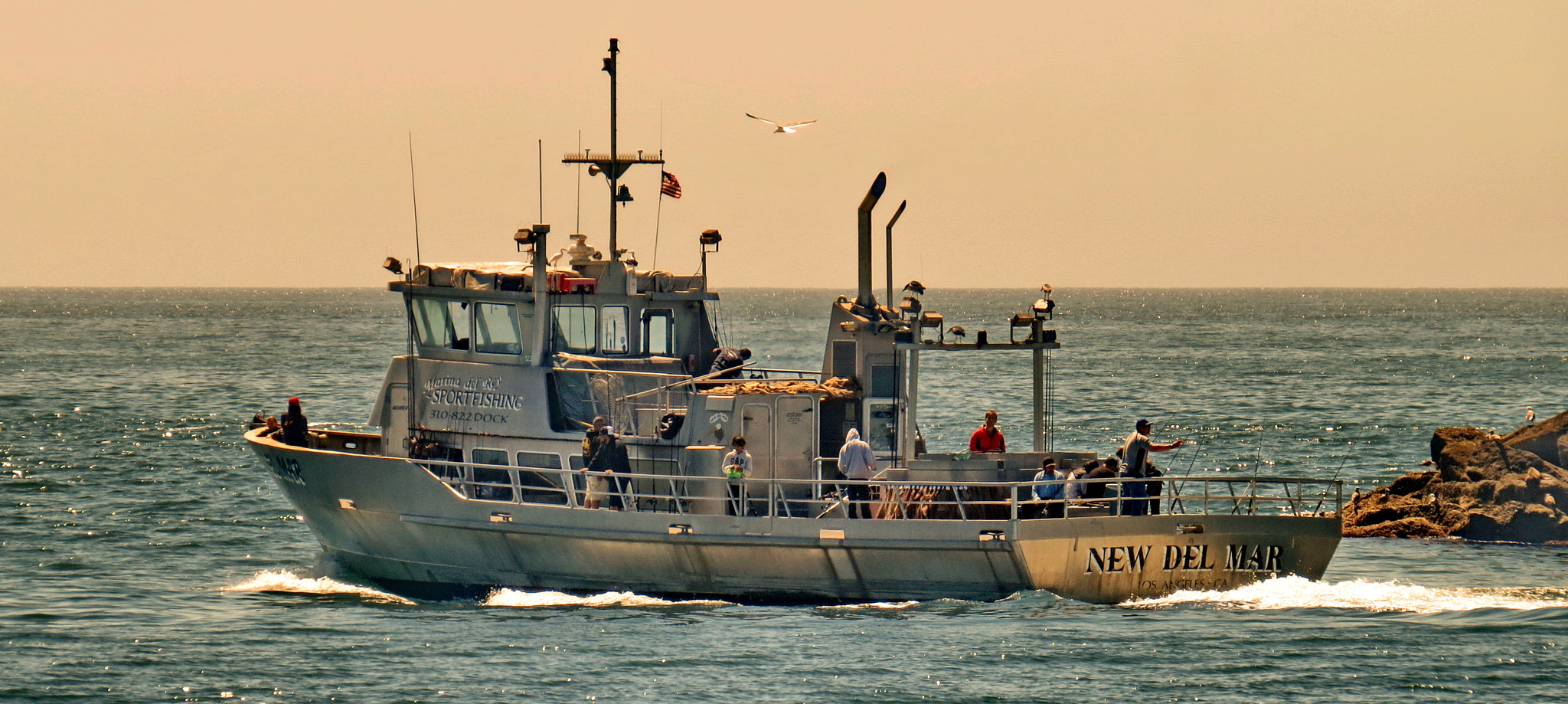 Canon PowerShot SX50 HS + 4.3 - 215.0 mm sample photo. Fishing boat heading out to sea photography