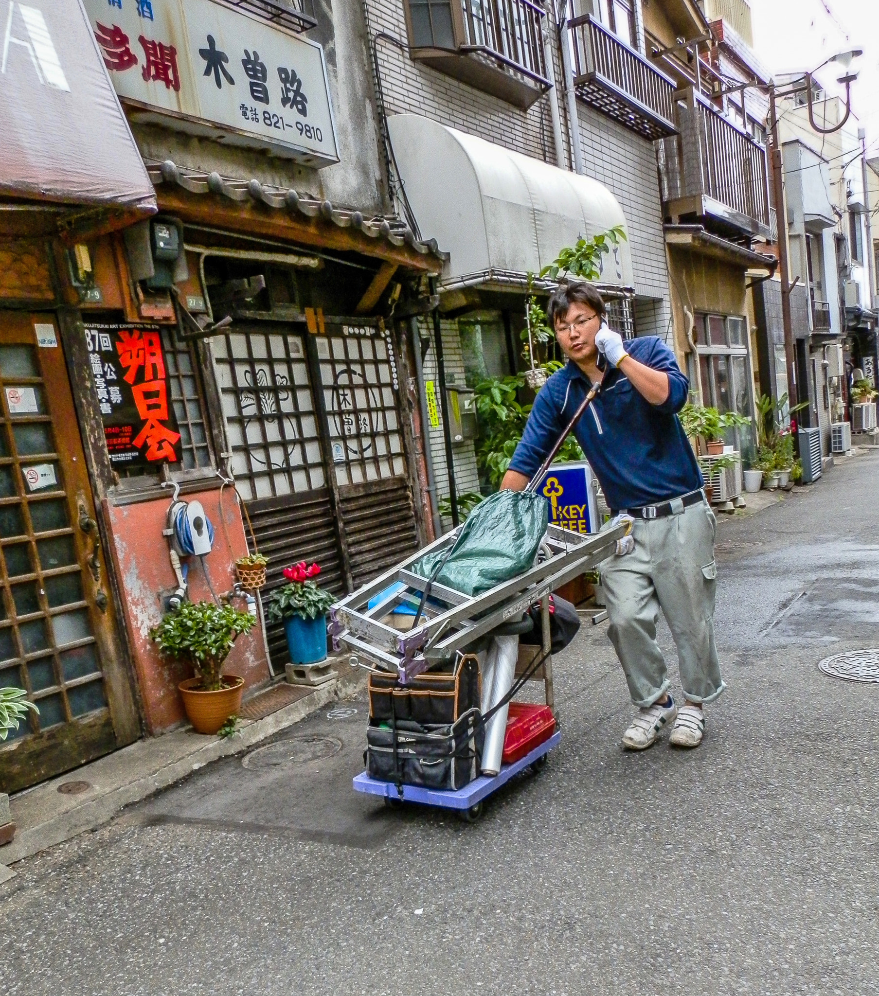 Olympus SZ-10 sample photo. Person carrying goods photography