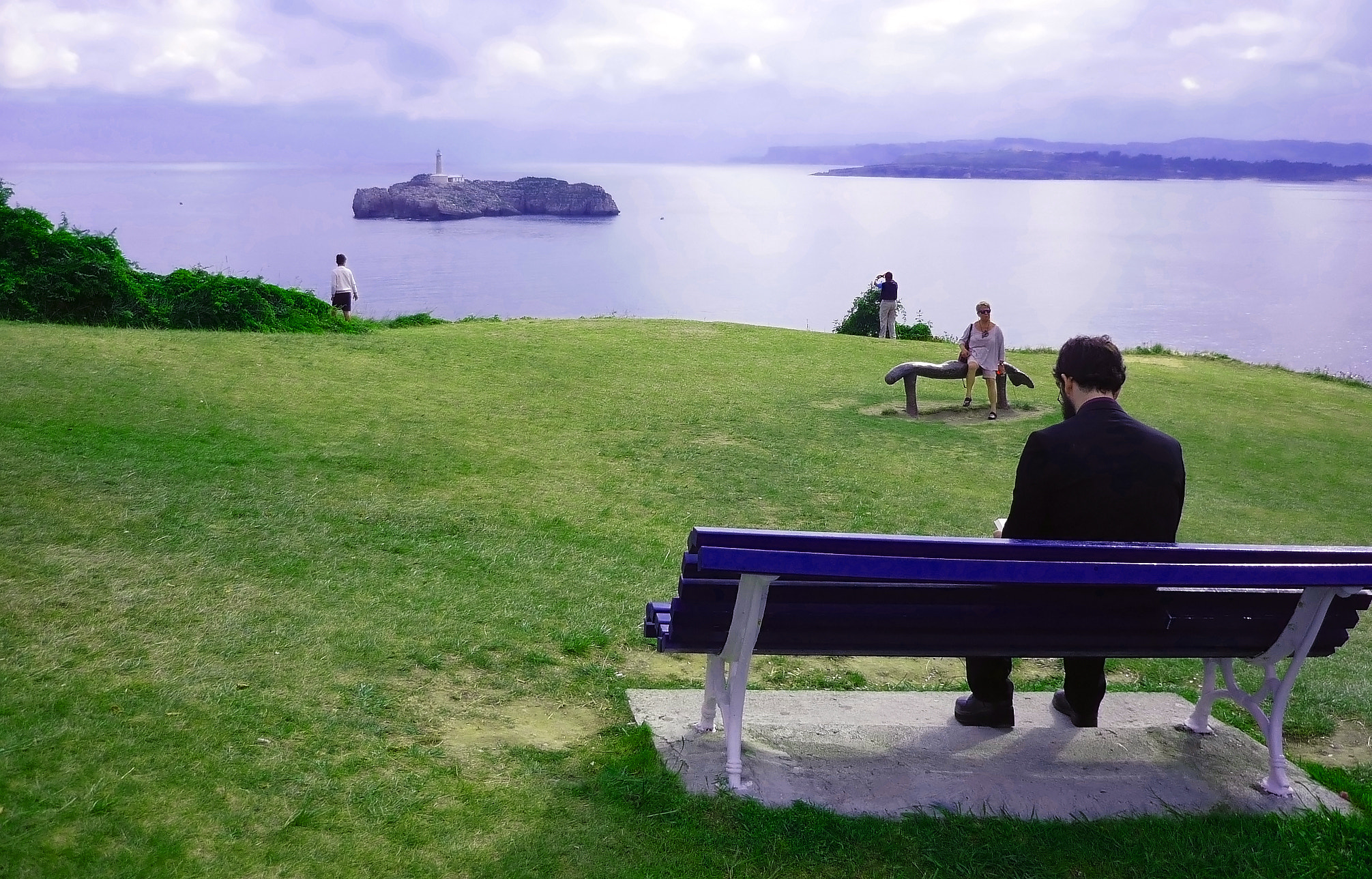 Panasonic Lumix DMC-FS3 sample photo. Unknown man sitting back to back reading by the sea photography