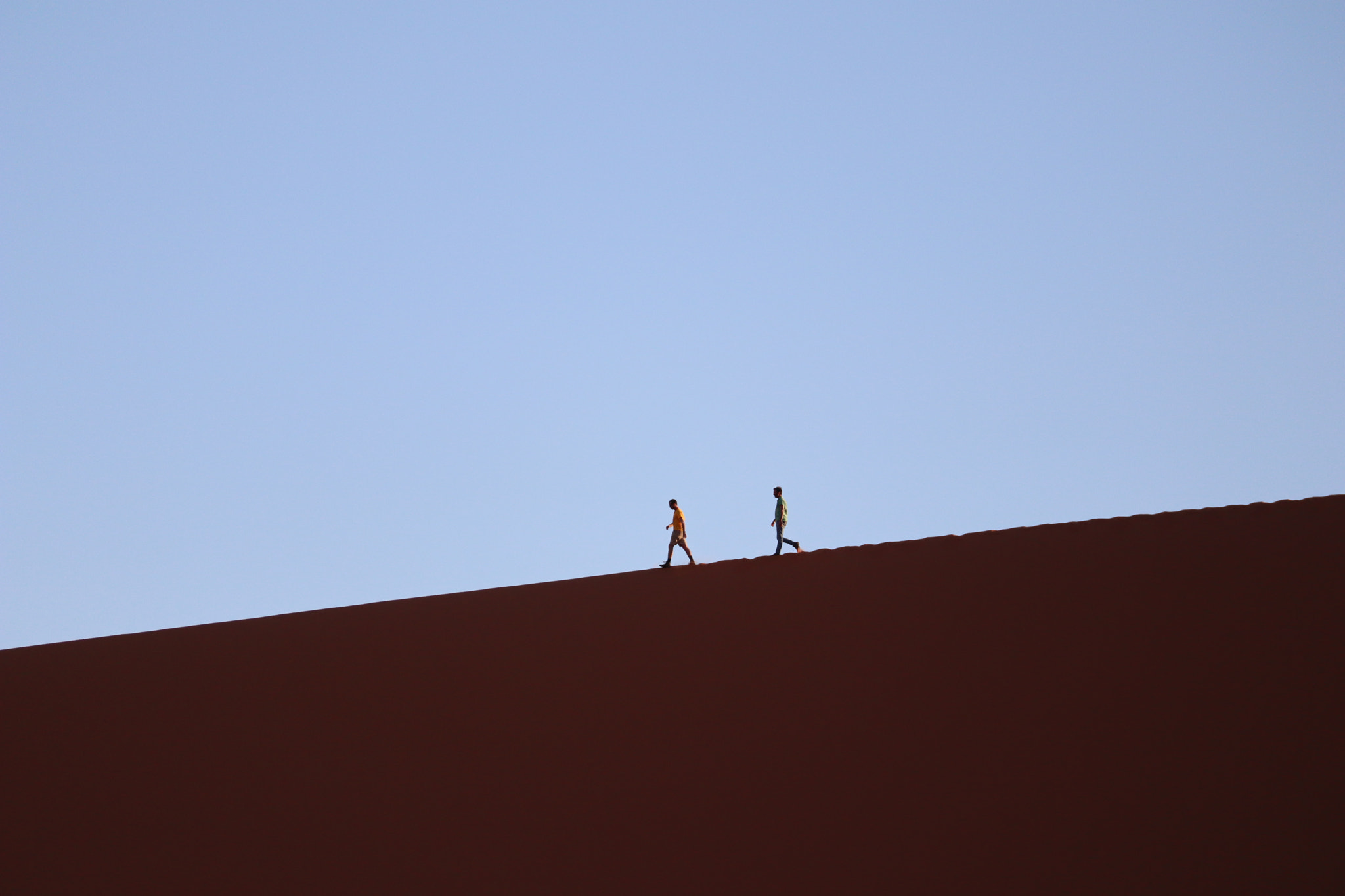 Canon EF-M 55-200mm F4.5-6.3 IS STM sample photo. Two persons walking on the dunes photography