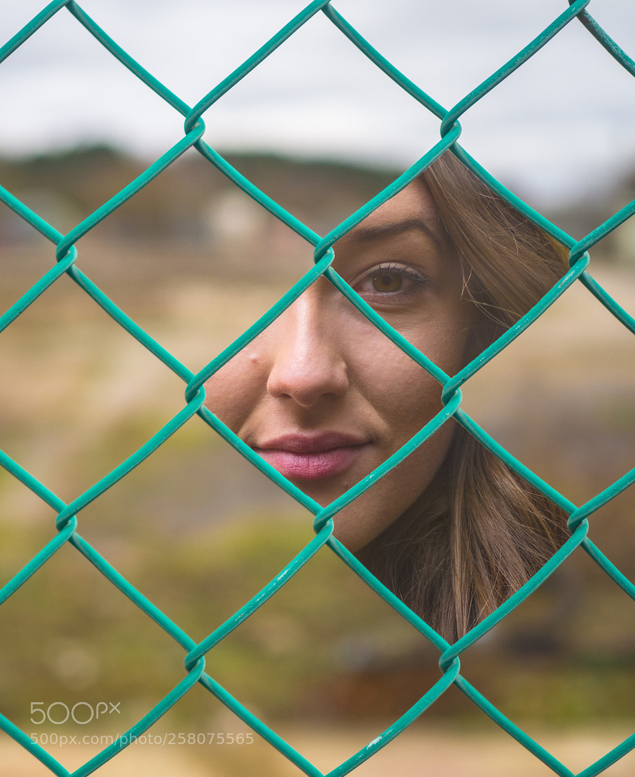 Olympus OM-D E-M10 sample photo. Portrait through fence photography