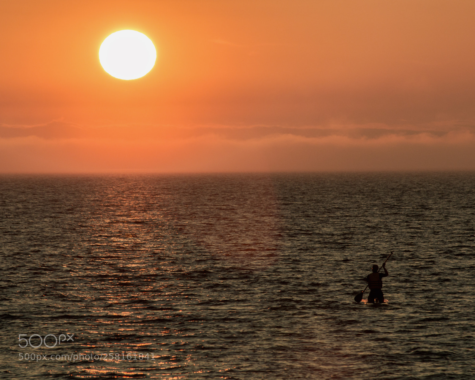 Canon EOS 70D sample photo. Man paddles toward ball photography