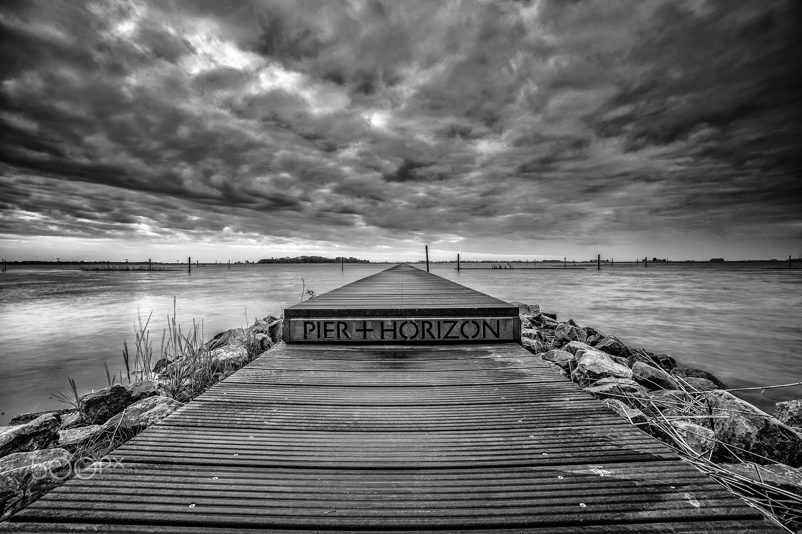 Sony Alpha DSLR-A900 sample photo. View of a long pier in the water with an infinite horizon photography