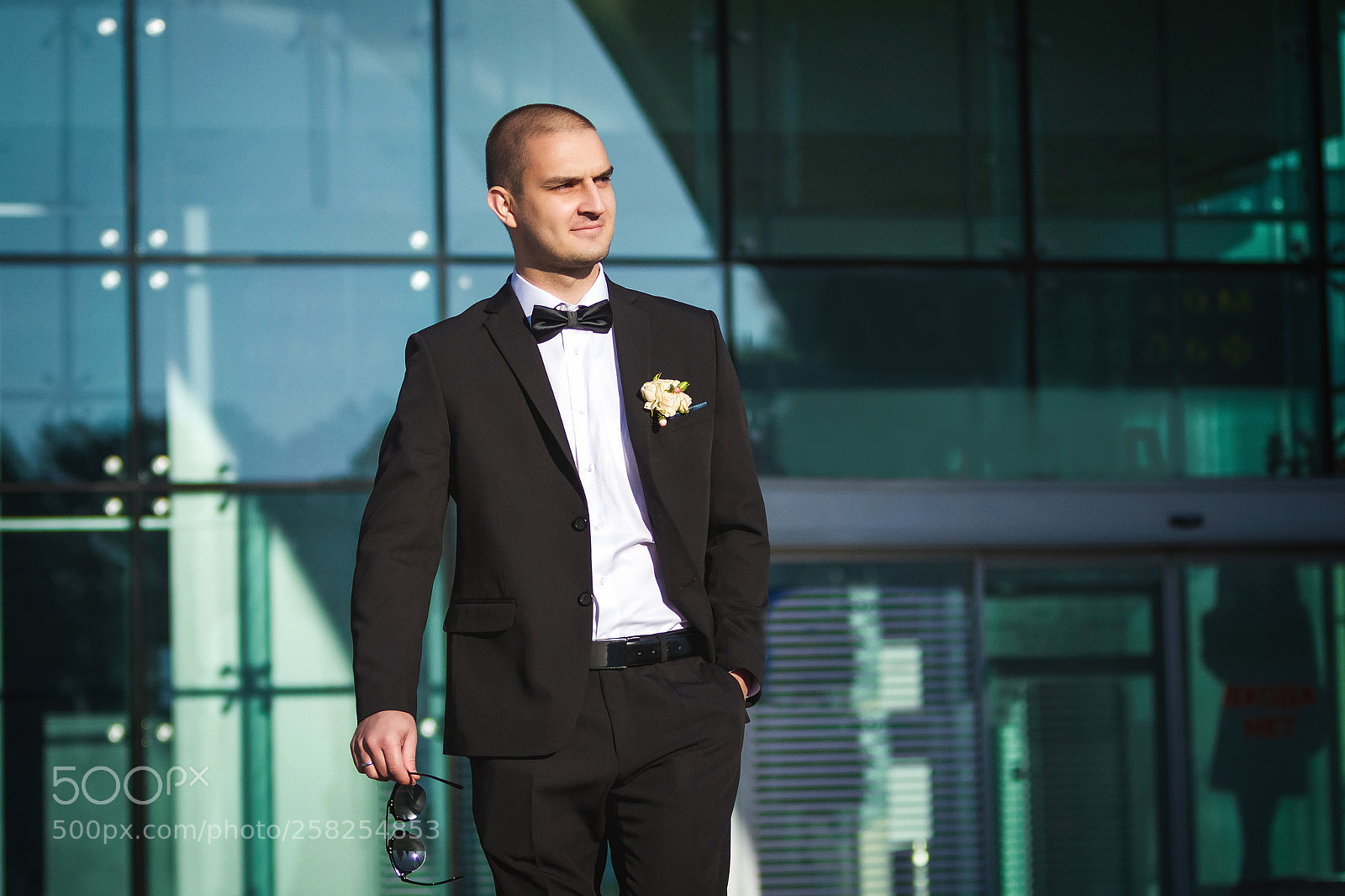Canon EOS-1D Mark IV sample photo. Handsome smiling groom holding photography