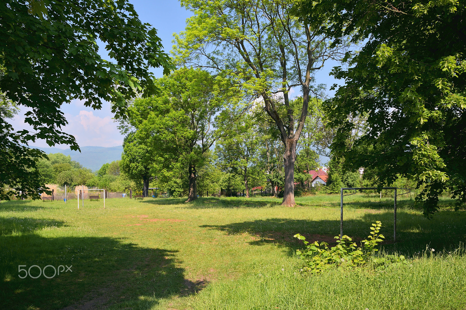 Nikon D5300 sample photo. Small grassy football field between trees in czech town of chabarovice with ore mountains on... photography