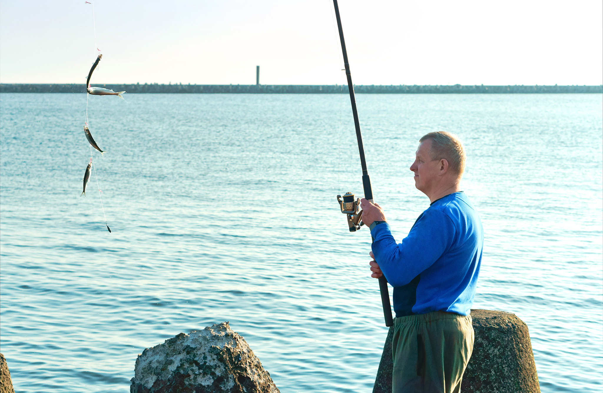 Sony Alpha NEX-3N sample photo. Fishing on a salak, a man caught a fish on a fishing rod, fishin photography
