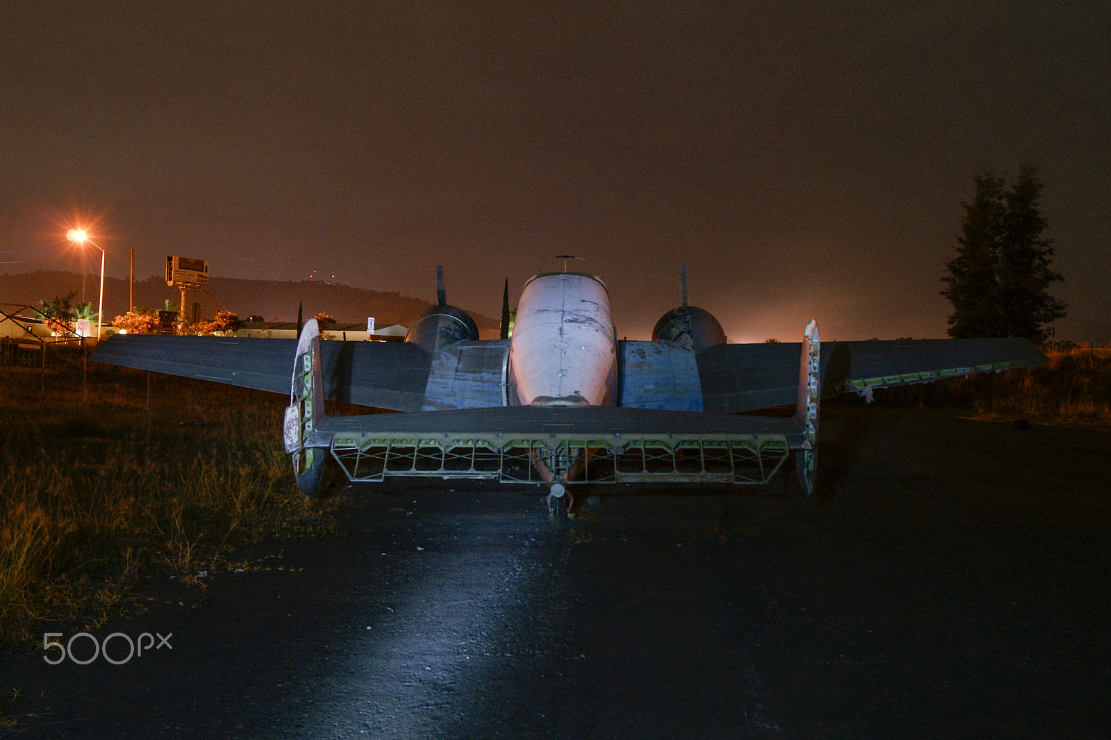 Sony Alpha DSLR-A380 sample photo. Rear view of an old beechcraft at night. photography