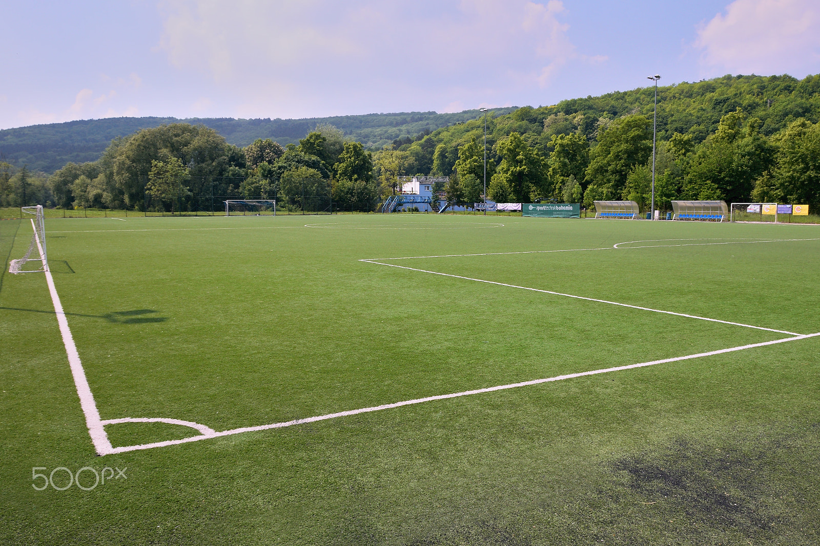Nikon D5300 sample photo. Bilina, czech republic - may 12, 2018: large grassy football field between trees in spring photography