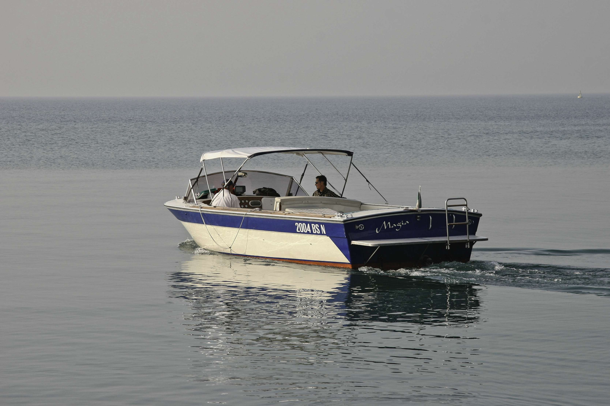A Motorboat Slowly Cruising on Lake Garda